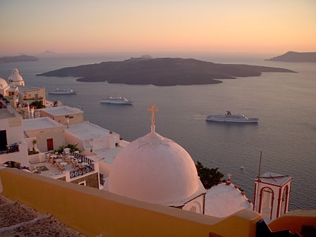 Santorini - view of active volcano in background at sunset