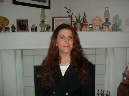 Carla at a pose in front of fireplace at home
