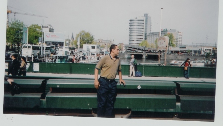 sexy red man in Amsterdam waiting on rail car