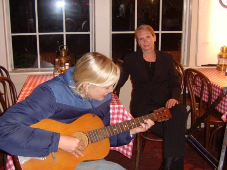 Daryl Hannah with me watching playing my 1910 parlor guitar