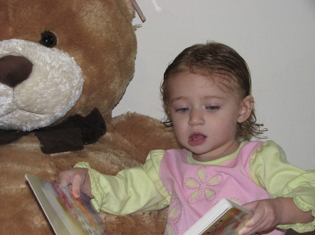 Nora reading her new bear a book