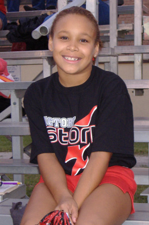 Kayla cheering at a school Football game