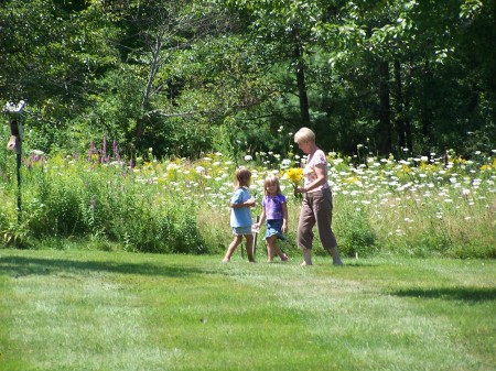Janet shows granddaughters our wild flower garden