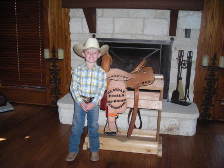 My son Kyle and his saddle he won