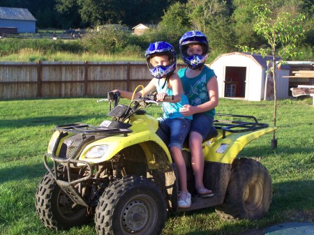 My youngest giving her cousin a ride on the quad