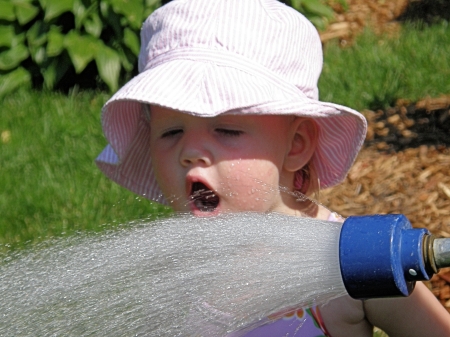 Getting a drink from G'ma and Papa's hose!