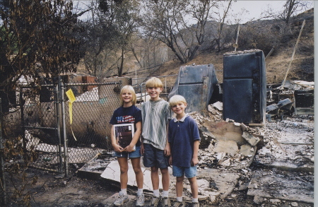 My three kids in front of what was our home.