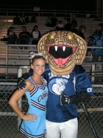 Sara's senior year cheerleading - With the mascot Striker