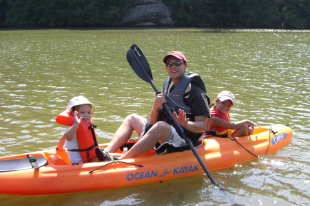 Ron and girls kayaking in the mountains