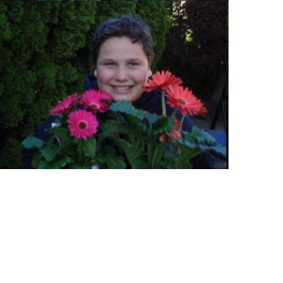 My son, Max, reluctantly with flowers