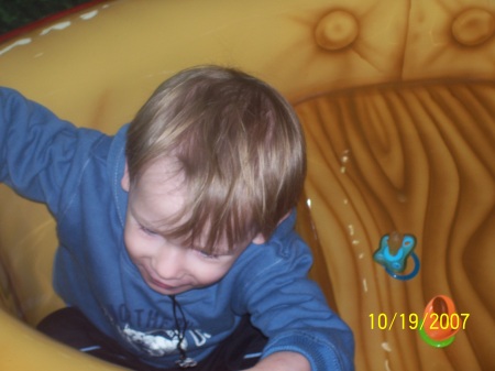 alex in boat at mall play area