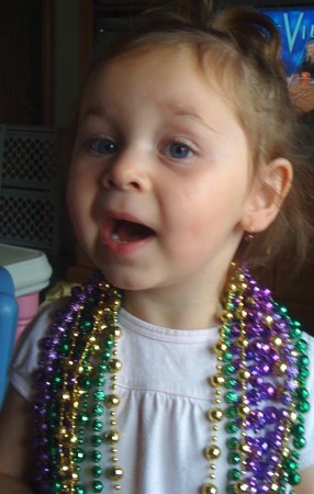 Alysa with Mardi Gras beads.