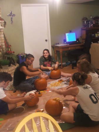 The kids and their friends carving pumpkins