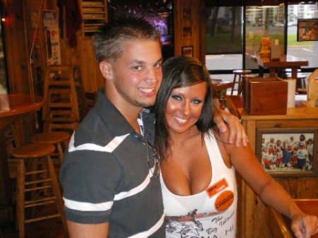 My oldest son Todd with a Hooter Girl in Florida