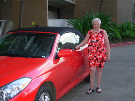 Mom & our convertible the night of the Luau