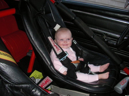 Gracie sitting in daddy's race car