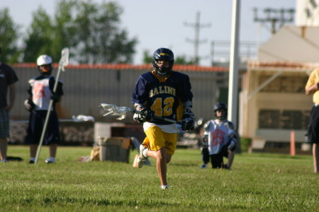 Greg playing lacrosse.