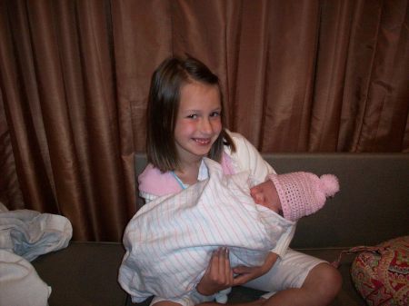 Mid Sis Madison holding Baby Mac
