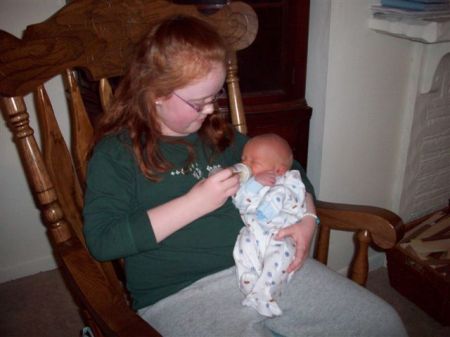 Rachel feeding her new brother Owen