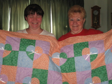 Mom and Steph with blanket they quilted