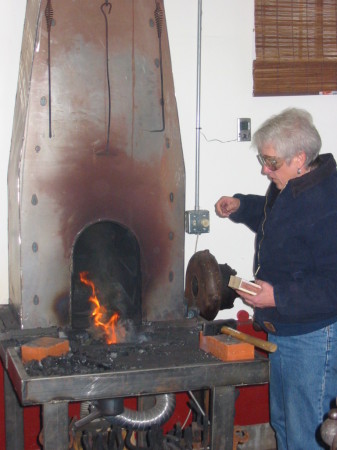 Pam lighting a fire