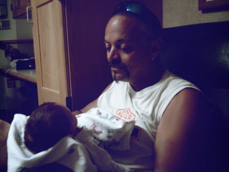 my dad holding Gabriel