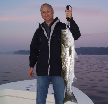 andy with big striper at dawn