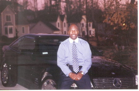 My husband sitting on his toy - 2001