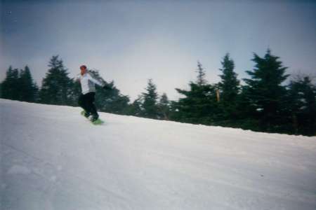 Me snowboard coming off of a jump