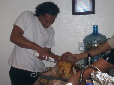 Maka carving his first turkey