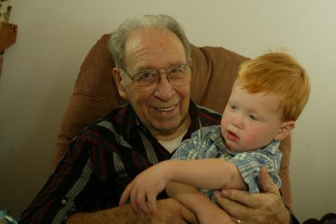 Dad holding Evan, Lee Ann's grandson