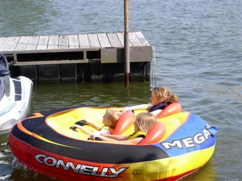 Richards children getting ride on Toms tube Sunbay Resort