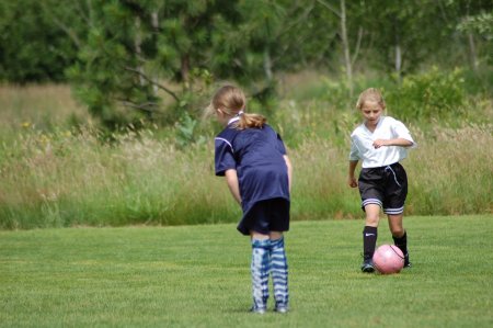 Kara (in white) playing soccer