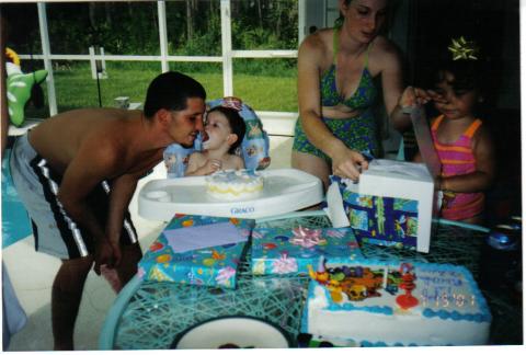 Alexis's first birthday and my kiss after the cake