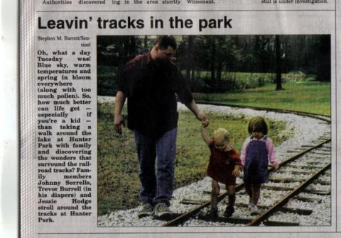 Johnny and our babies at the park in the paper