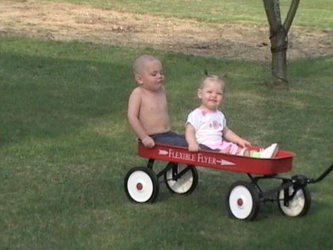 Jamie and Riley ridin in the wagon