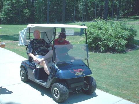 Don Hardison and Roger Nelson driving beer cart