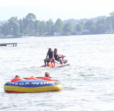 Richards children getting ride on Toms tube Sunbay Resort