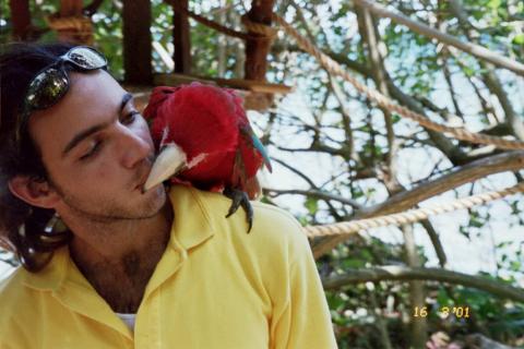 A local Kissing a parrot