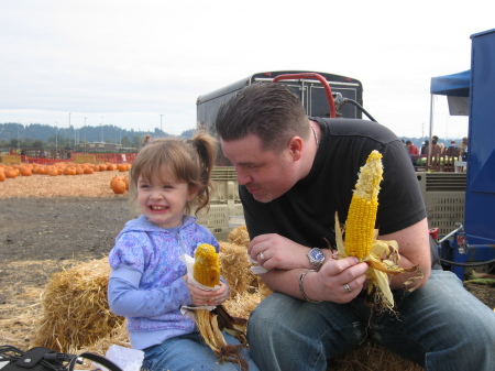 Sharing roasted corn with my daughter