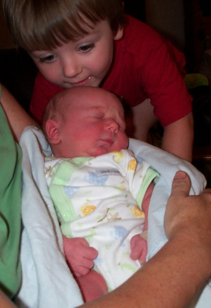 Owen meeting his baby brother, Noah.