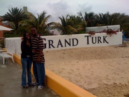 rita & terrance in front of turk & caicos sign