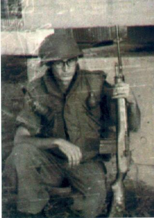 Larry Rader in front of machinegun bunker