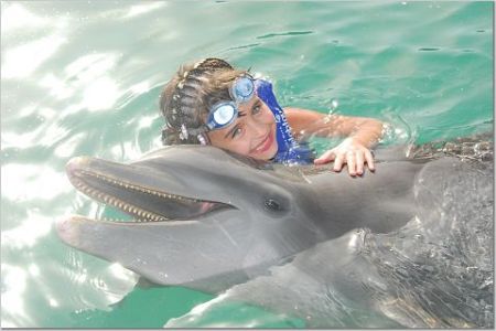 Eryn swimming with the dolphins in Mexico