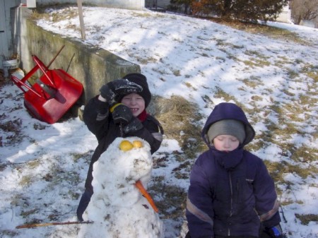 Boys making snowman