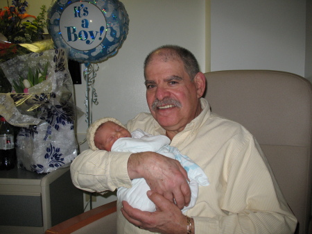 Proud Poppee holding new born grandson