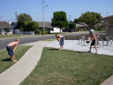 The fellas playing football in the yard