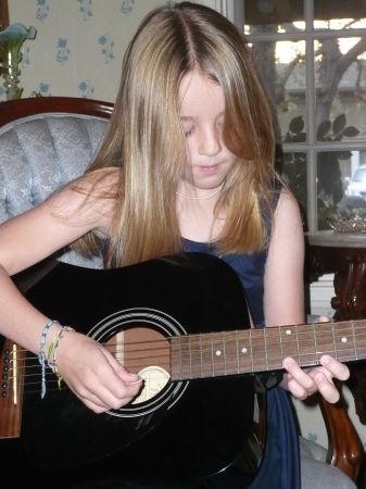 Alex playing her guitar