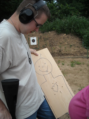 me holding target and shotgun