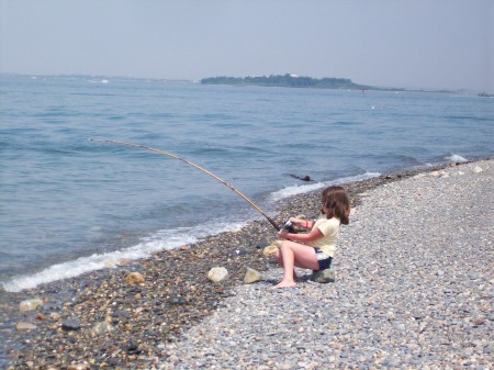 mariah my 10 yr old landing a striper